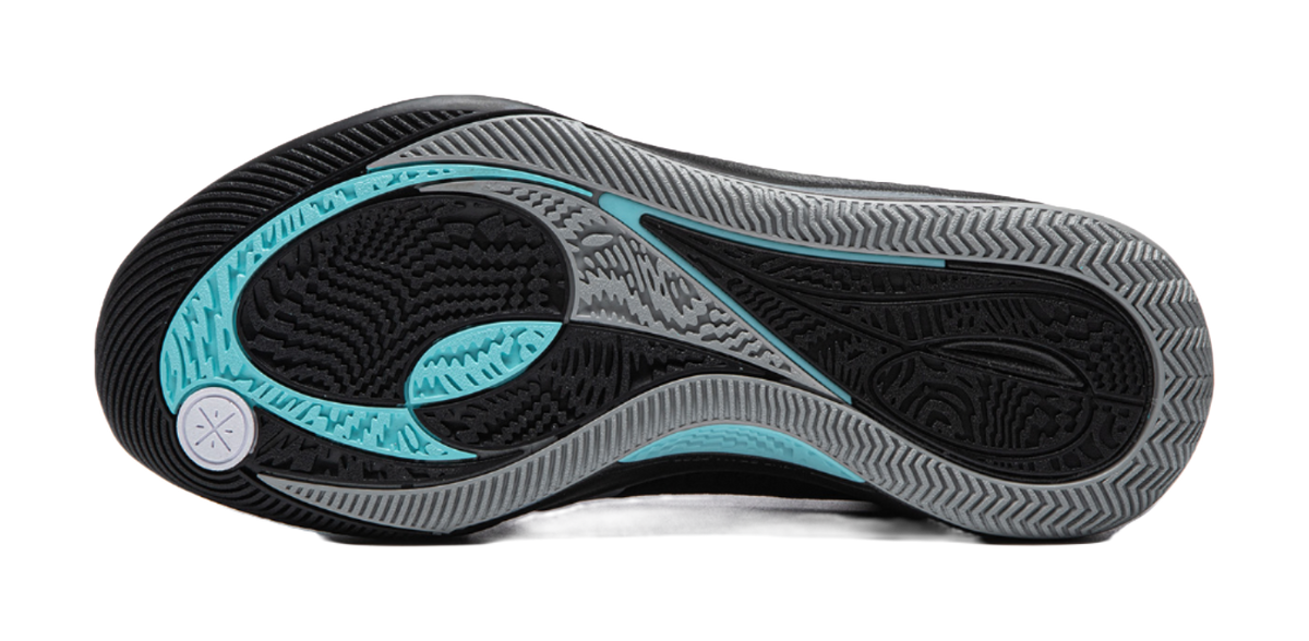 Black basketball shoe outsole with teal traction zones and textured tread pattern