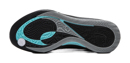 Black basketball shoe outsole with teal traction zones and textured tread pattern