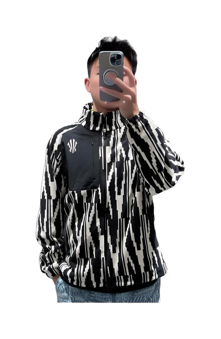 Unisex zip-up sweatshirt jacket worn; black-and-white all-over pattern with small chest logo.