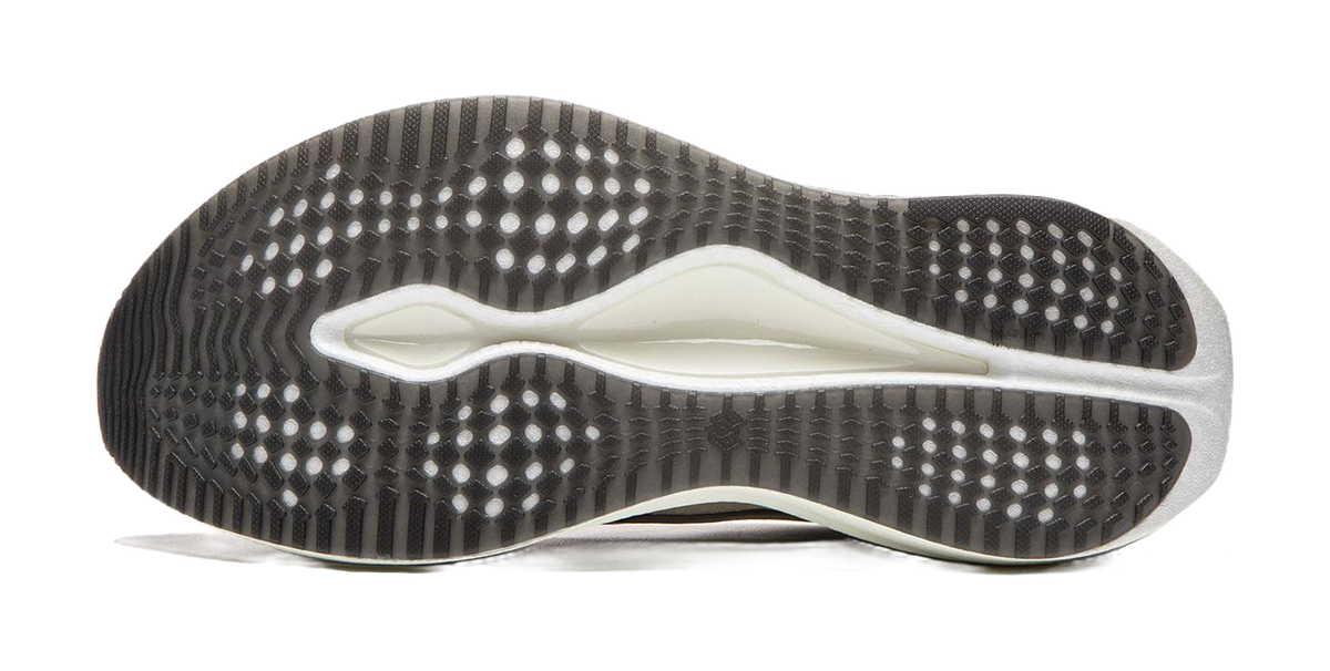 Champagne white running shoe outsole with grippy dot pattern and blue-tinted edge