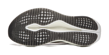 Champagne white running shoe outsole with grippy dot pattern and blue-tinted edge