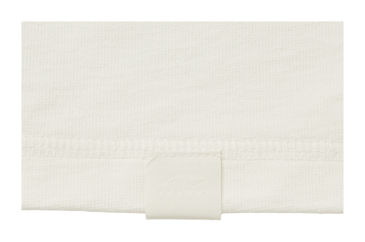 Ivory long-sleeve T-shirt hem with inner size label
