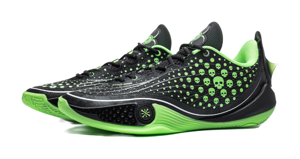 Black low basketball sneaker with neon green laces, skull-dot upper, and green midsole