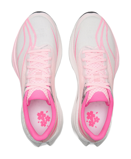 Pink running shoe interior with floral print insole and white lace-up upper