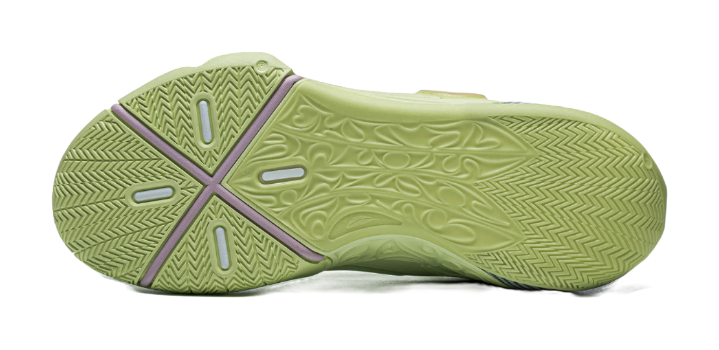 Green basketball shoe outsole view with herringbone traction pattern and purple heel tab