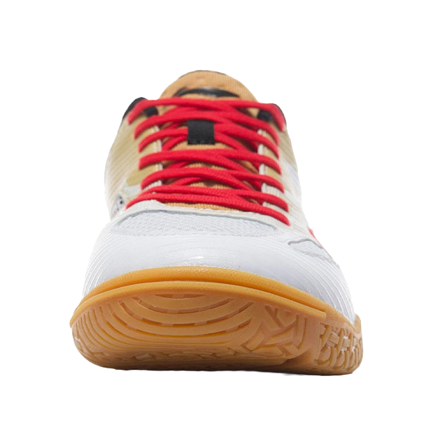 White table tennis shoe underside with red laces, gum outsole, toe-heel close-up.