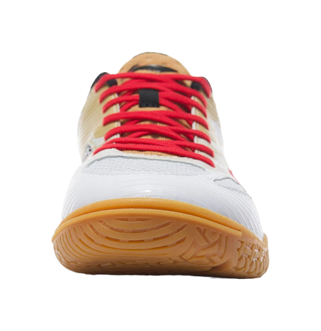 White table tennis shoe underside with red laces, gum outsole, toe-heel close-up.