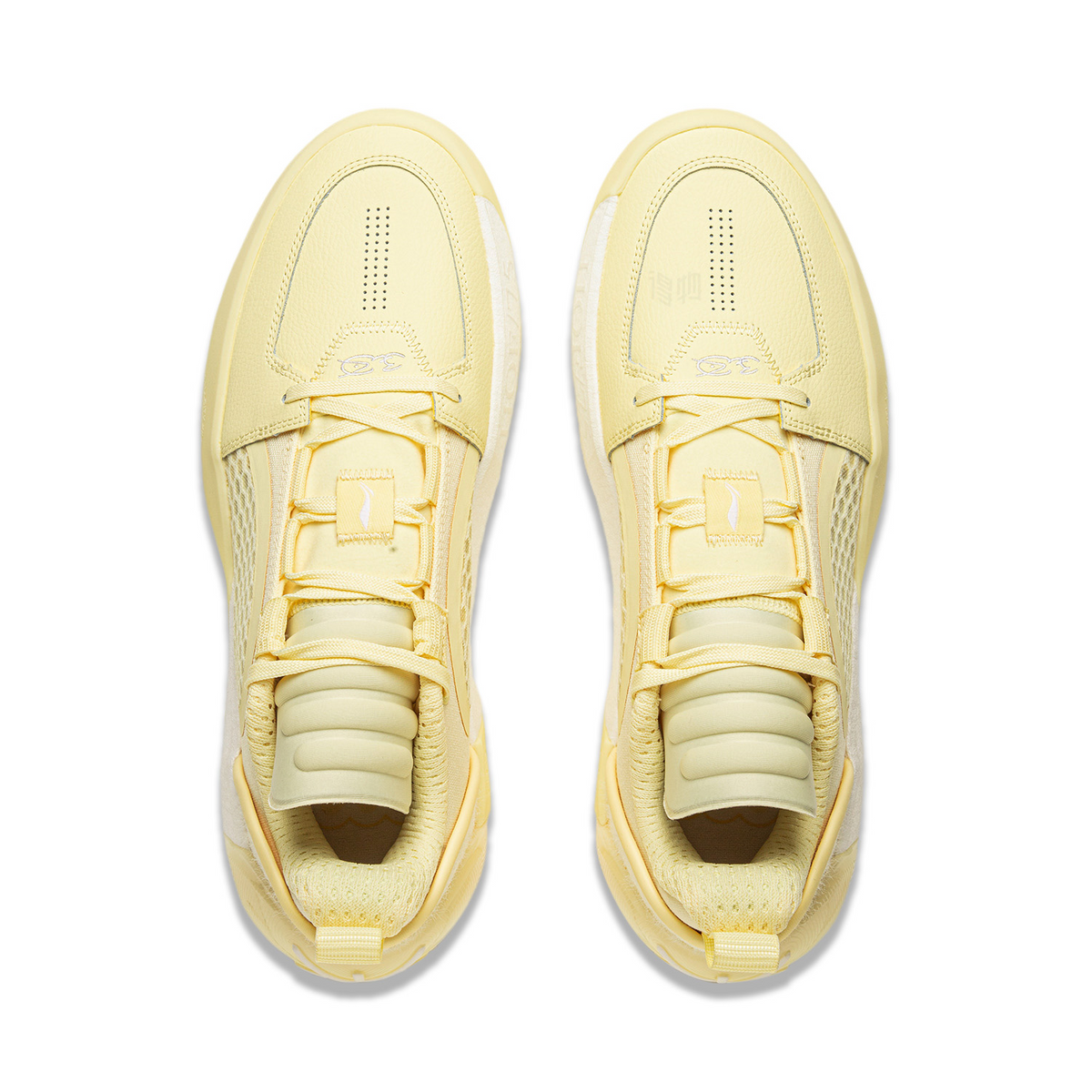 Pair of men's basketball shoes, light yellow lace-up design with cushioned collar