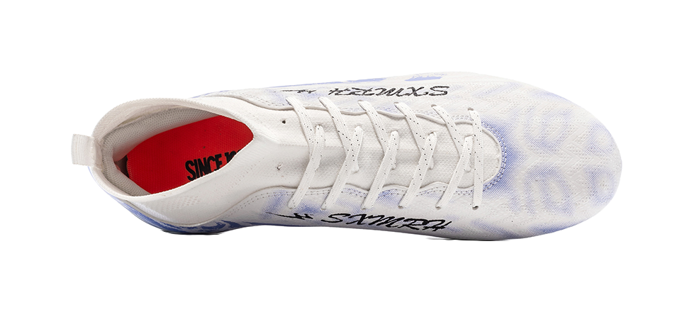 White soccer shoe with red lining at heel and lace-up closure