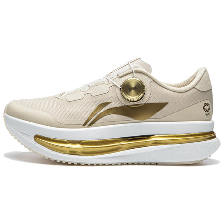 Women’s running shoes in light beige with gold BOA dial and gold midsole stripe.