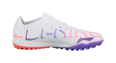 White soccer shoe side view with purple and pink accents and red outsole studs