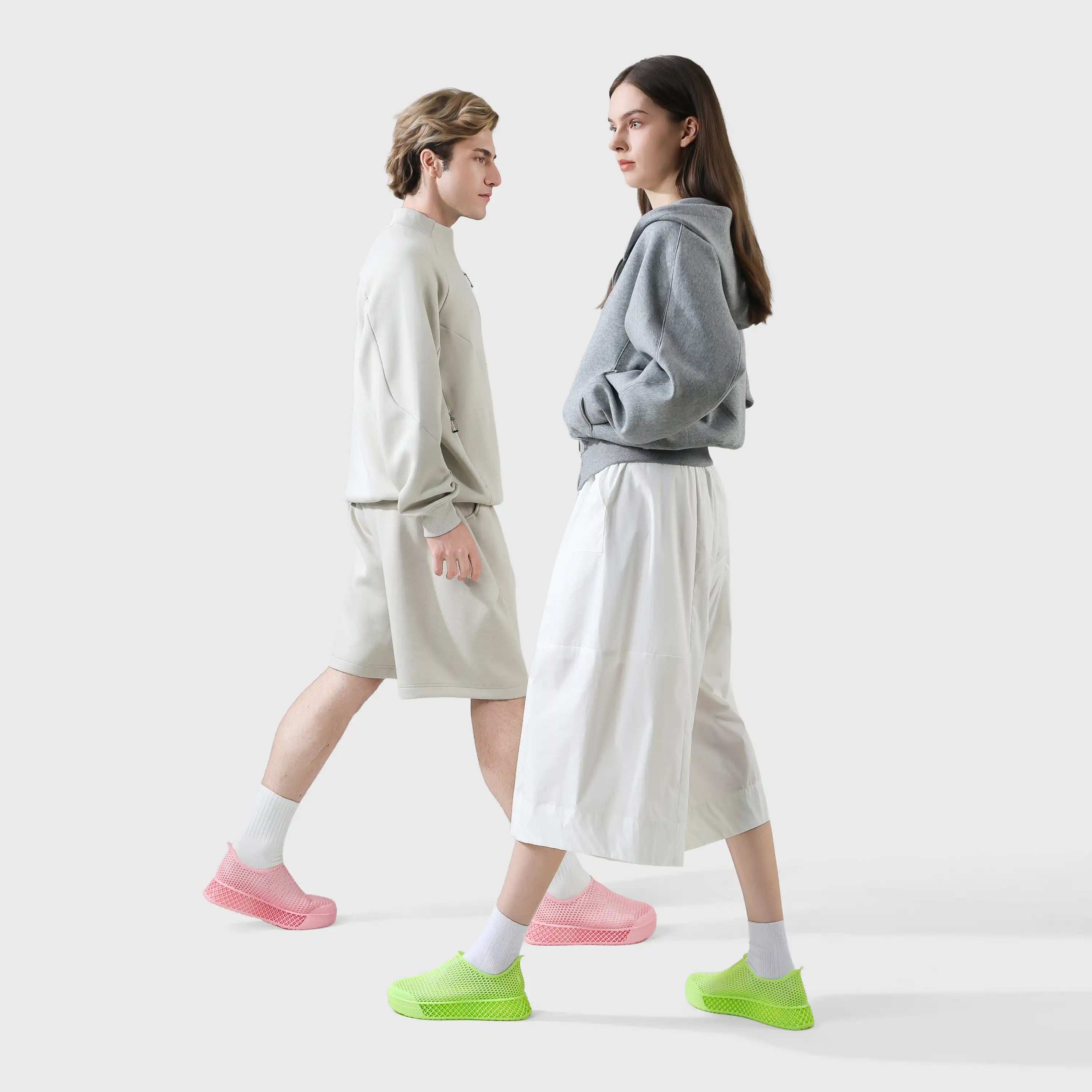 Casual sneakers in green with pink accents, slip-on style on two models