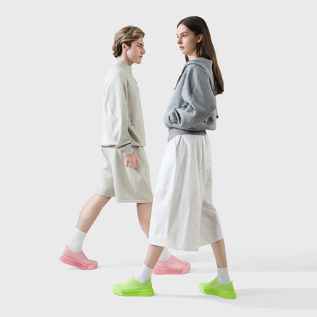 Casual sneakers in green with pink accents, slip-on style on two models
