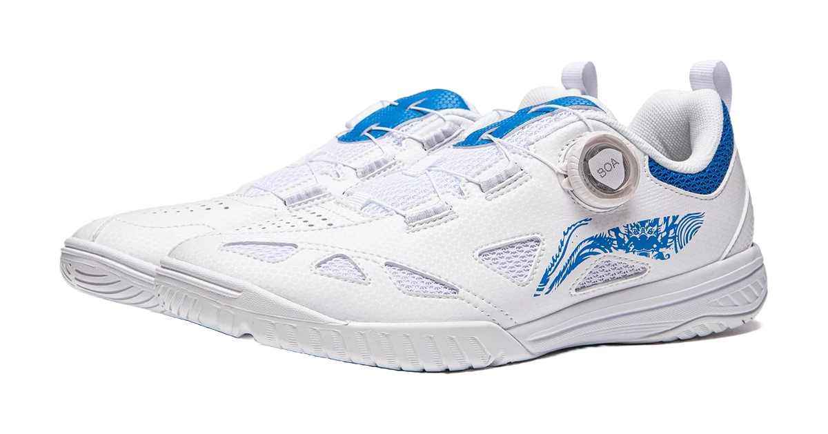 White table tennis shoe with blue accents, front straps, and BOA dial on the tongue.
