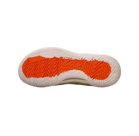 Mid basketball shoe outsole with deep tread and orange rubber traction sections