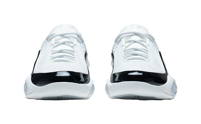 White and black basketball shoe, heel-toe side view with glossy toe cap