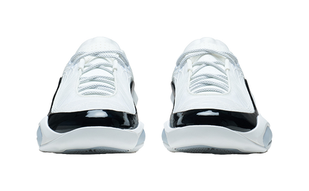 White and black basketball shoe, heel-toe side view with glossy toe cap