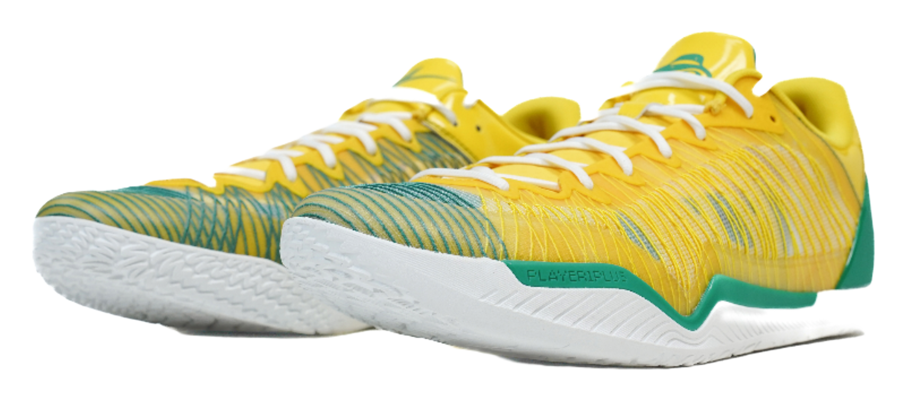 Pair of yellow basketball shoes with green accents and white textured outsoles