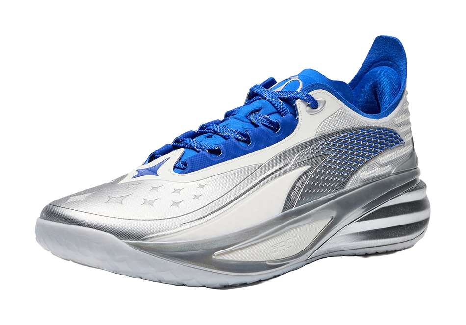 Basketball shoe in white with silver side panels and blue laces, star graphic on toe.