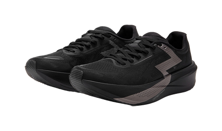 Two black low running shoes with textured uppers and gray accent stripe