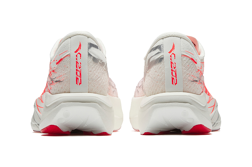 White running shoes with red stripe logo on heel and patterned back cushioning.