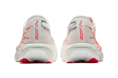 White running shoes with red stripe logo on heel and patterned back cushioning.