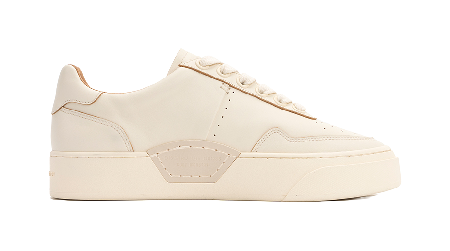 Antique white low-top skate shoes with padded collar and side stripe detail