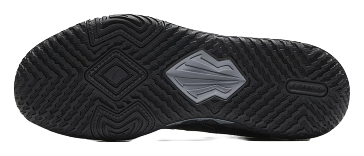 Black basketball shoe outsole with deep traction tread and logo center