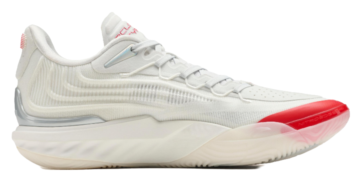 Unisex basketball shoe, side view with white knit upper and red outsole