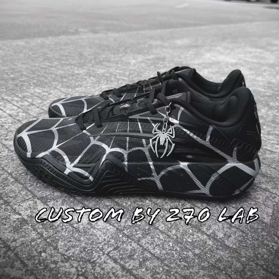 Black basketball shoe with white spiderweb lines and lace-up design, side view.
