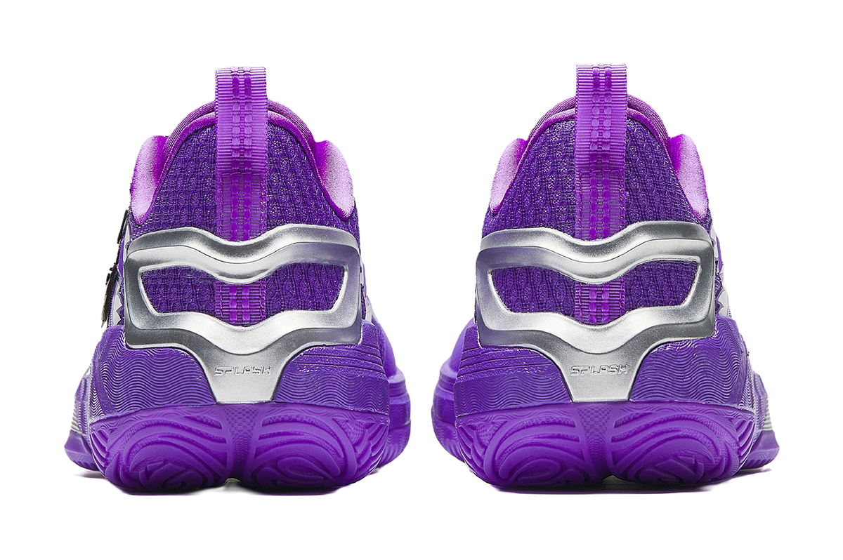 Purple basketball shoes with silver heel counter and textured rubber outsole tread.