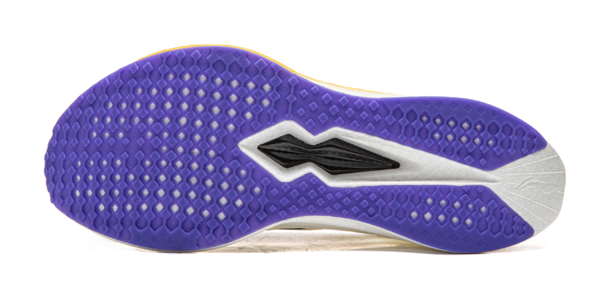 Purple outsole of champagne white running shoe with textured traction pattern