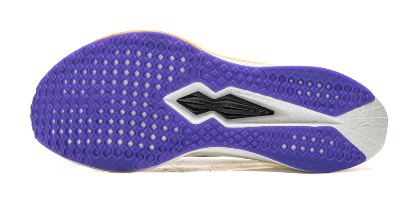 Purple outsole of champagne white running shoe with textured traction pattern