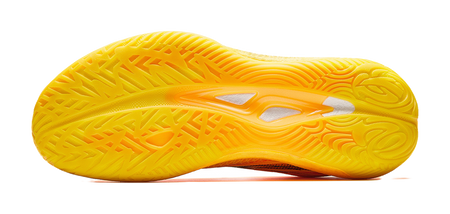 Yellow basketball shoe outsole with patterned tread and orange midfoot graphic