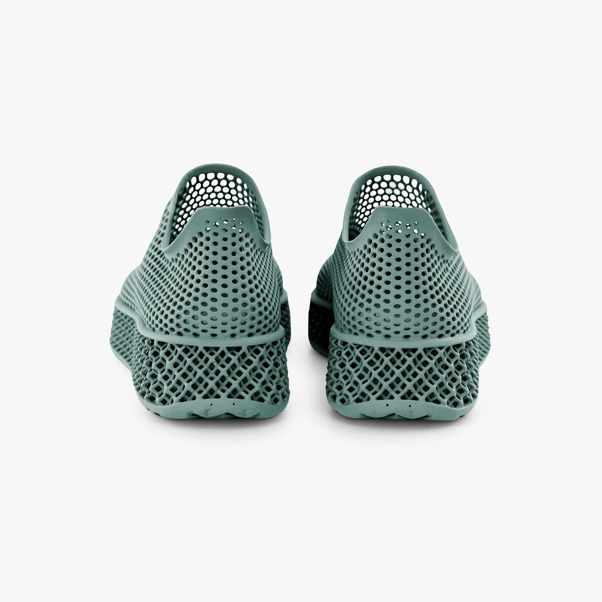 Green 3D-printed sneakers rear view with perforated upper and textured sole