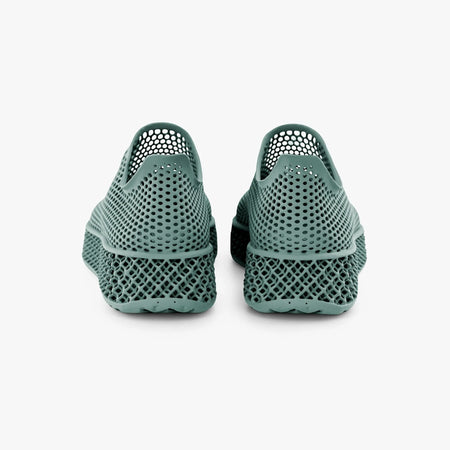 Green 3D-printed sneakers rear view with perforated upper and textured sole