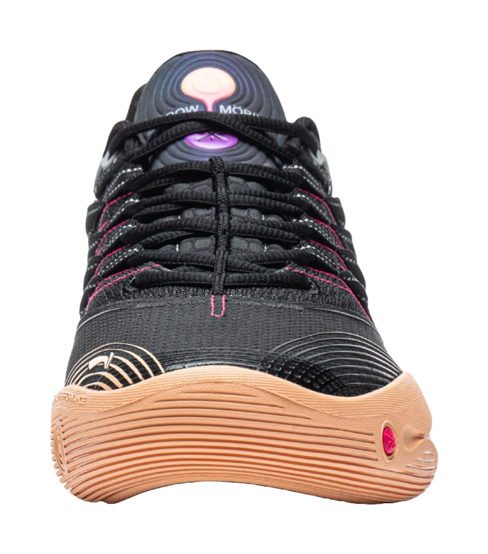 Low basketball shoe close-up: black upper with pink laces and gum toe bumper.