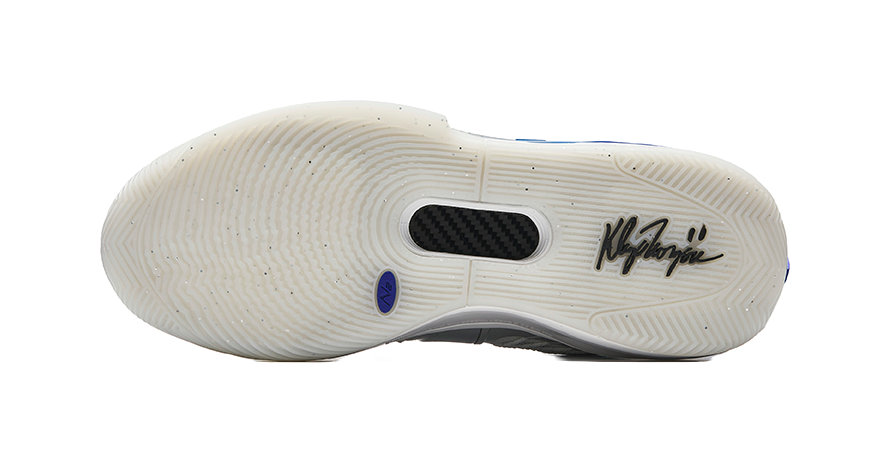 Silver low basketball shoe outsole with traction pattern and blue stripe