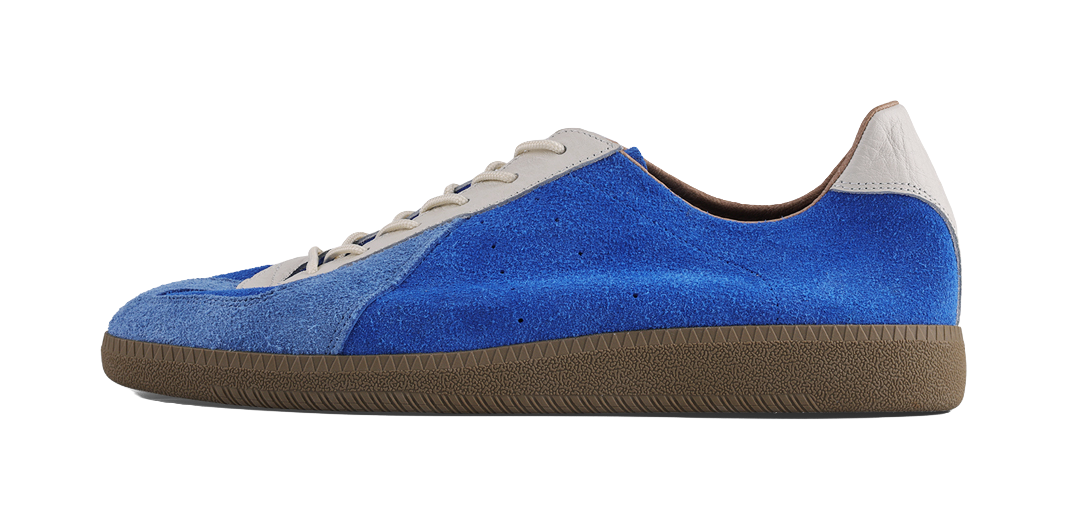 Blue low-top training sneaker with white lace panels and brown textured sole.