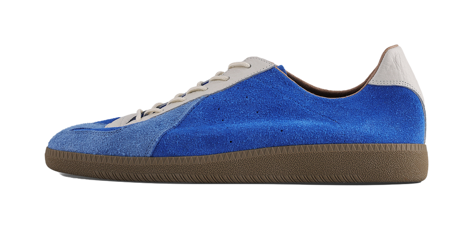 Blue low-top training sneaker with white lace panels and brown textured sole.