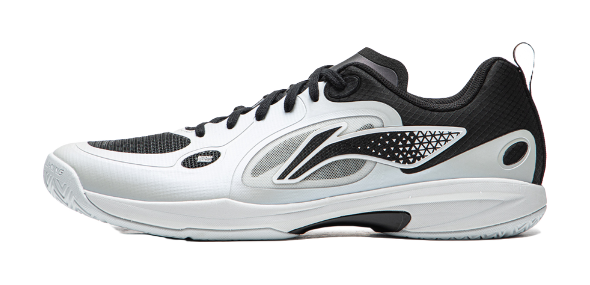 Table tennis shoe with white upper, black lace-up, and side logo accents