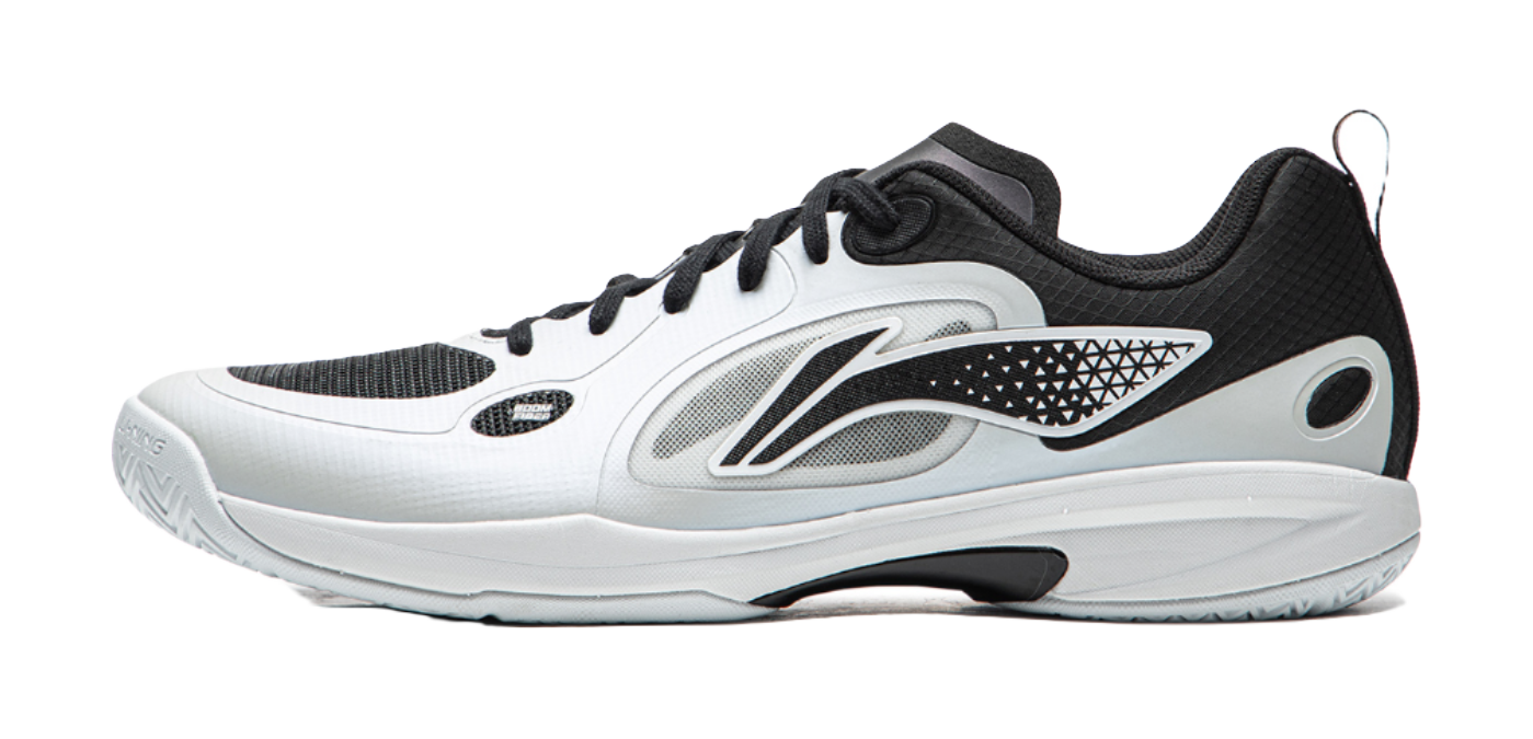 Table tennis shoe with white upper, black lace-up, and side logo accents