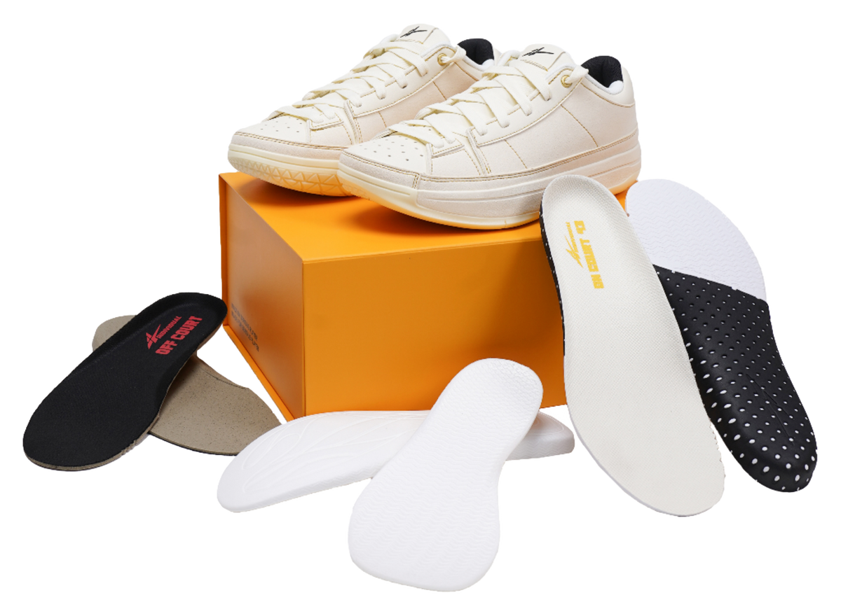 Cream basketball shoes with extra insoles and orange shoebox
