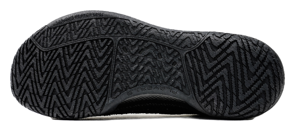 Black low-top basketball shoes, rubber outsole with zigzag tread pattern.