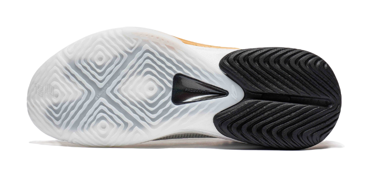 Basketball shoe outsole in white and black with patterned traction tread