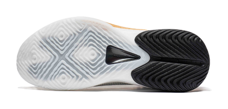 Basketball shoe outsole in white and black with patterned traction tread