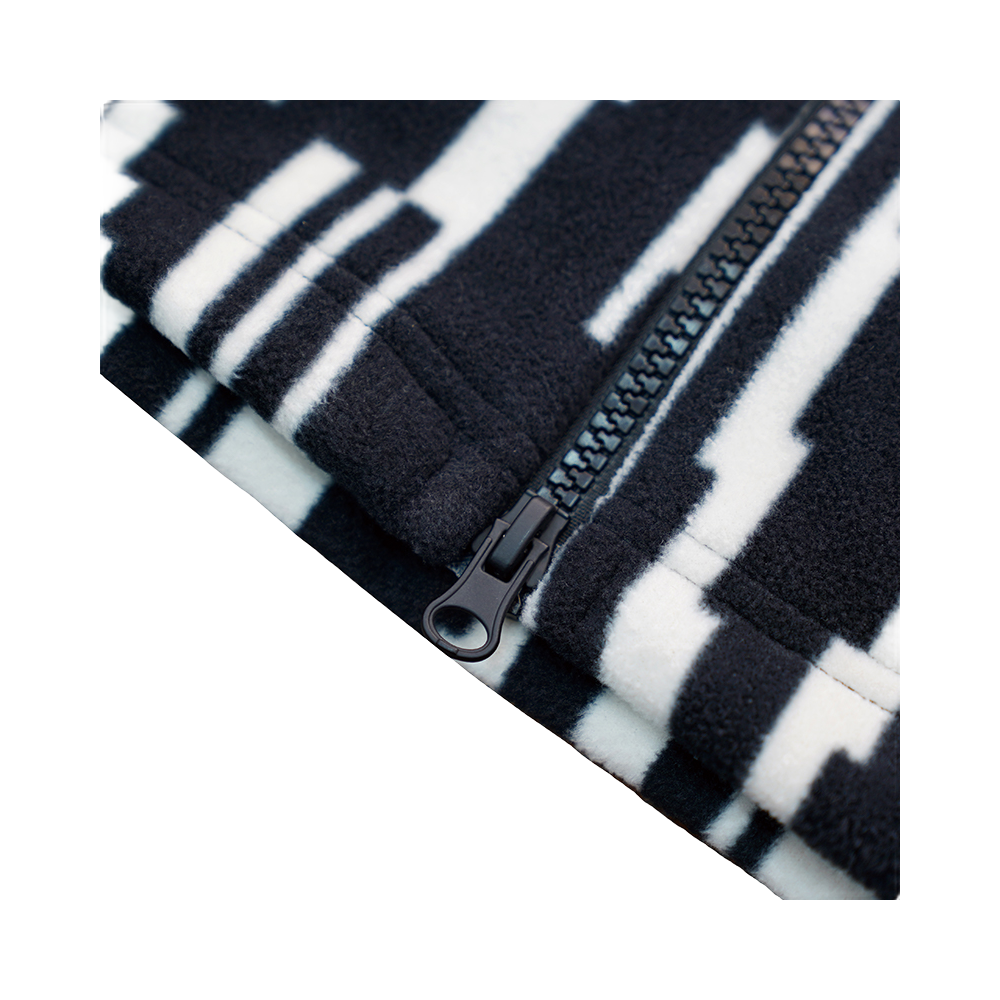 Zip sweatshirt jacket fabric close-up with black-and-white all-over pattern and zipper pull.