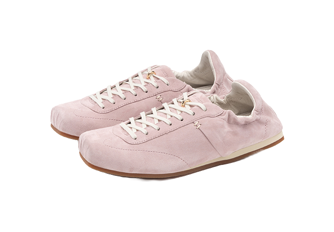 Mist Pink low-top trainers close-up with white laces, padded collars, and gum sole.