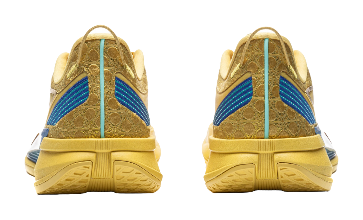 Bright gold low-top sneakers with blue heel stripe and ribbed rubber outsole