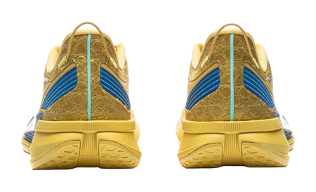 Bright gold low-top sneakers with blue heel stripe and ribbed rubber outsole